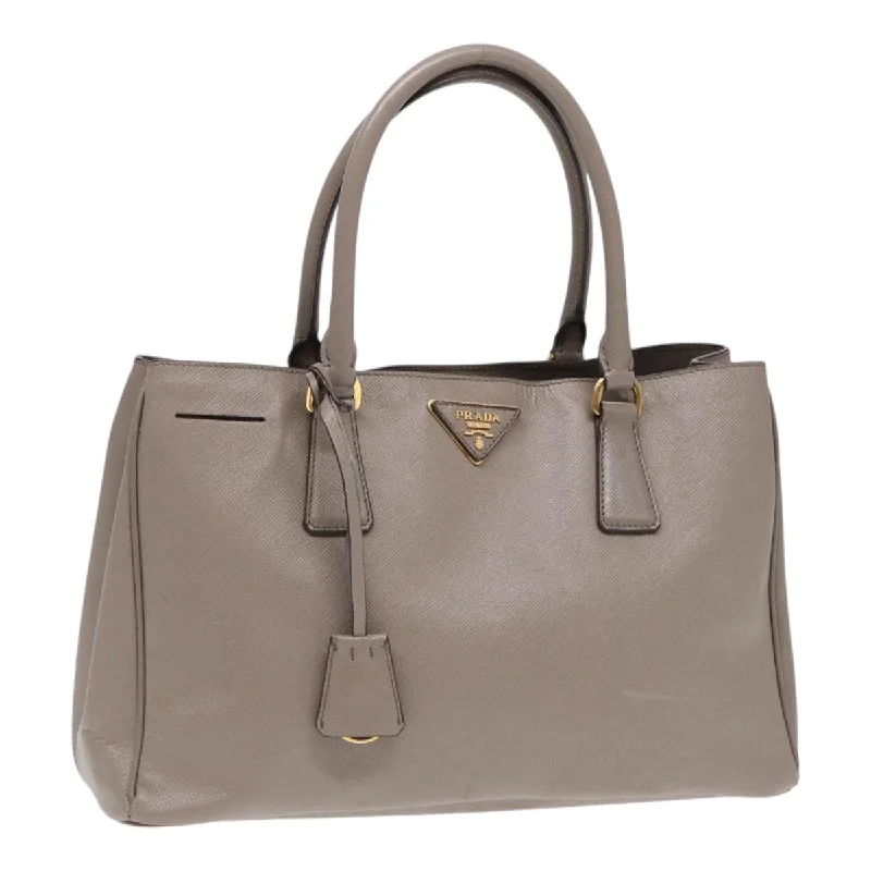 Prada Cleo bags with a contrast - colored interior for visual interestPRADA Hand Bag Safiano leather Gray Gold Auth ep5342